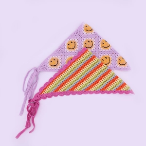 Detail of handmade crochet daisy bandanas featuring smiley face and colorful striped patterns