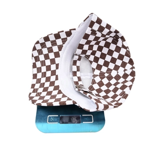 Brown and white checkerboard pattern baseball cap on scale showing 76g lightweight