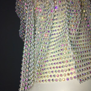 Macro shot of grid mesh rhinestones and sparkling colorful beads on a fishnet headpiece