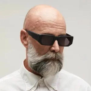 Close-up of a man wearing thick matte black rectangular sunglasses with dark grey lenses