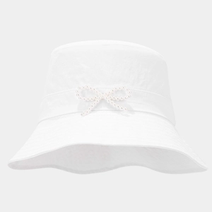 Detail of white bucket hat with ribbon and bow made of decorative pearls on the side