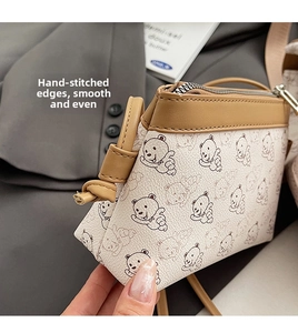 Gros plan du motif d'ours sur sac en cuir PU avec couture premium et fermeture éclair
