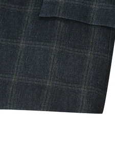 Macro view of dark blue and black plaid fabric texture on a fashion blazer jacket