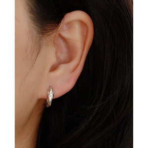 Close-up of S925 silver star earrings with sparkling cubic zirconia on model
