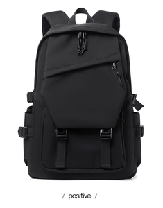 Front view detail of a black waterproof nylon backpack with tactical straps and buckles