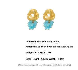 Detail view of geometric golden twist earrings with sky blue glass beads and measurements