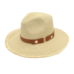 Detail of straw fedora hat featuring a brown leather belt and gold metal buckle