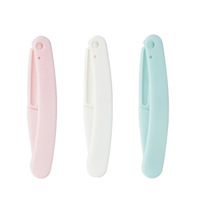 Detailed view of pink, white, and blue foldable eyebrow razors with safety macro blades