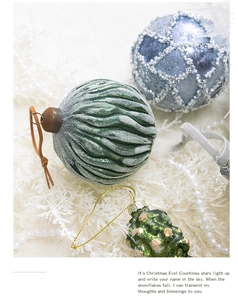 Close-up of frosted green spiral ornament and blue beaded lattice ball for Christmas