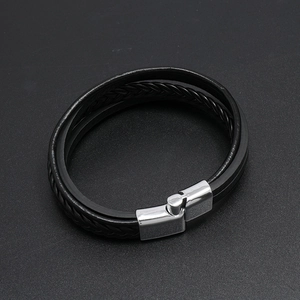 Detail of multi-layer black braided leather bracelet with silver magnetic metal clasp