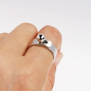 Minimalist silver geometric ring with spherical ball clasp design on finger