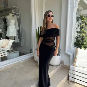 Detail of elegant black off-shoulder dress featuring sheer mesh waist and slim fit design