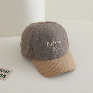 Close-up of kids plush baseball cap featuring Nice embroidery and corduroy brim