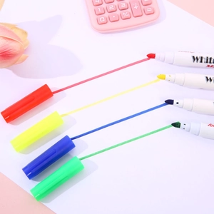 Close-up of four colorful floating magic pens in red, yellow, blue, and green on white paper