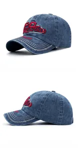 Detail of vintage washed blue denim baseball cap with 3D red embroidery and contrast stitching
