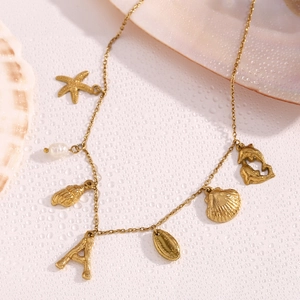 Detailed shot of 18K gold plated necklace with starfish, shell, and dolphin charms