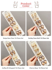 Detail of 10-piece cartoon hair ties set including cute bears and smiley face icons