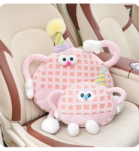 Close-up of pink waffle texture monster car pillows on leather seats in two sizes
