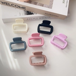 Collection of six square plastic hair claws in assorted matte pastel and neutral colors