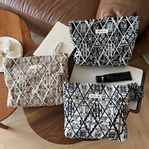 Handmade linen cosmetic bag with geometric embroidery and zip closure in three colors
