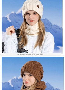 Close-up of thick knit winter hat and scarf set with mountain pattern leather patch