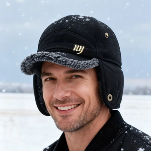 Winter wool baseball cap with ear flaps and fleece lining for men in snowy outdoor setting