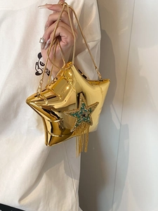 Detail of gold star bag with rhinestone accents and hanging metallic chain tassels