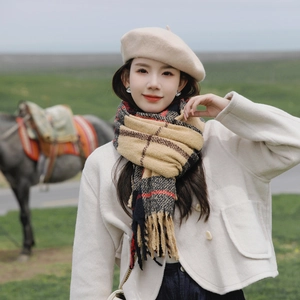 Classic plaid tassel scarf in beige and red thick knit worn by a model in a natural setting
