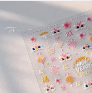 Macro detail of 3D embossed Lunar New Year nail stickers with gold lion and floral motifs
