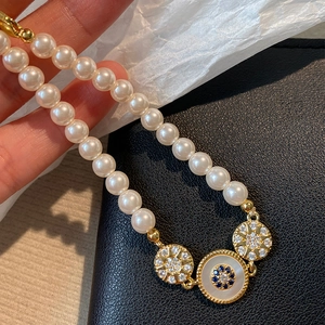 Bracelet en perles plaqué or 18 carats avec breloques œil et détails en zircone