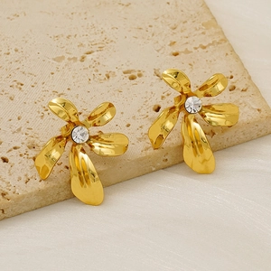 Boucles d'oreilles fleur dorées avec cristal central sur support en pierre