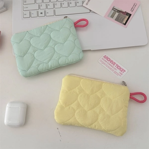 Quilted heart pattern storage bags in mint green and yellow with vibrant pink straps
