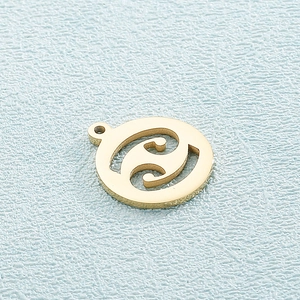 Detailed close-up of a gold-plated circular zodiac charm for DIY jewelry making