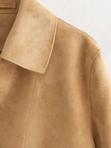 Detailed macro view of the camel faux suede jacket collar and stitching texture