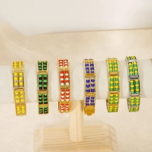 Close-up of double-layer beaded bracelets in various colors on a velvet display stand