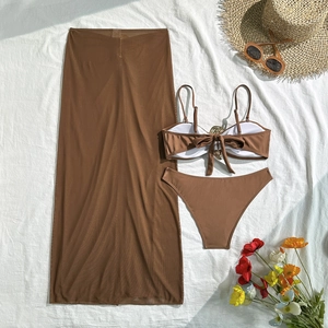 Flat lay of brown 3-piece bikini set with gold buckle detail and matching sarong skirt