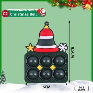 Christmas bell pop it fidget keychain in green silicone with festive snowflake patterns