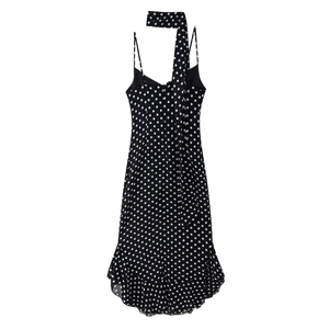 Sleeveless black polka dot mini dress with halter neck and ruffled hem for summer wear