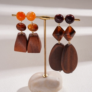 Retro bohemian earrings with resin beads and brown wooden blocks on golden T-stand
