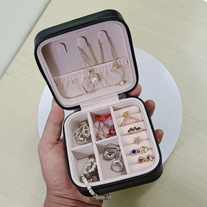 Portable black jewelry travel case with zipper closure and soft pink velvet interior lining