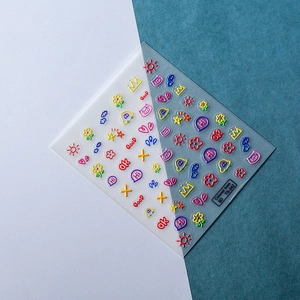 Macro view of 5D embossed nail stickers featuring colorful pig and doodle icons
