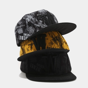 Detail of stacked hip-hop snapback hats featuring 3D letter W embroidery and rebel prints