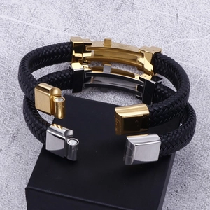 Close-up of woven leather bracelets with H-shaped metal magnetic clasps on jewelry box