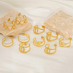 Collection of golden double-layer geometric earrings on beige stone and white silk