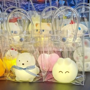 Cartoon animal night lights with warm glow in clear gift bags with blue handles