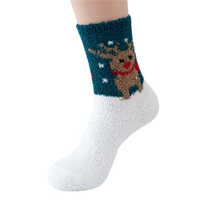 Detail of warm coral fleece Christmas socks featuring reindeer embroidery and snowflakes
