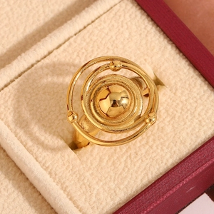 Macro detail of 18K gold-plated double-loop ring with celestial spheres on velvet stand