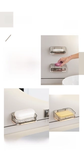 Detail of wall-mounted self-draining soap holder with translucent grey finish and trim