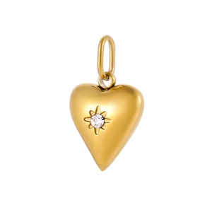 Macro view of golden heart pendant with center zircon and starburst engraving detail