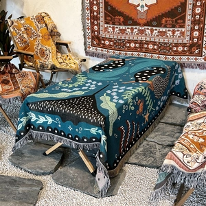 Bohemian dark blue woven picnic blanket with white tassels and green leaf patterns